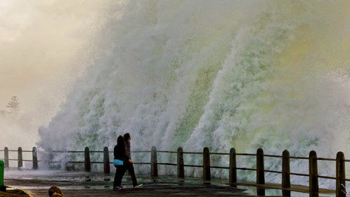 Onlookers watch on as a giant wave crashes on the promenade at Sea Point, Cape Town, South Africa. Picture: Adrian de Kock / 4roomz.com 