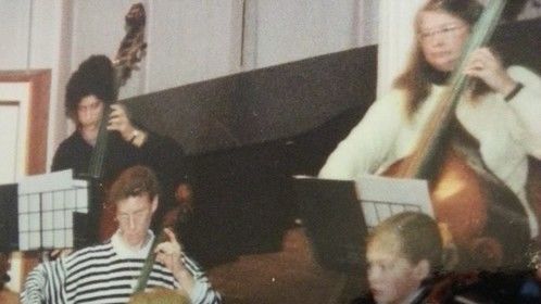 Rosamund Pike and I playing 'cello in school orchestra.  Our taste in sweaters has greatly improved with age (as have our looks).  I stuck with the music career .....  she earns a lot more than me ....  :-)