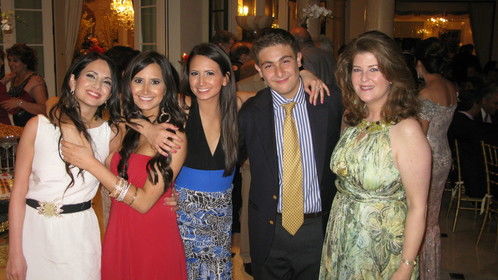 At a party celebrating Persian New Year (these are nieces and nephew); I'm on the far right in the greenish dress.